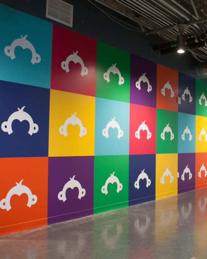 Survey logos on colorful tiles on wall