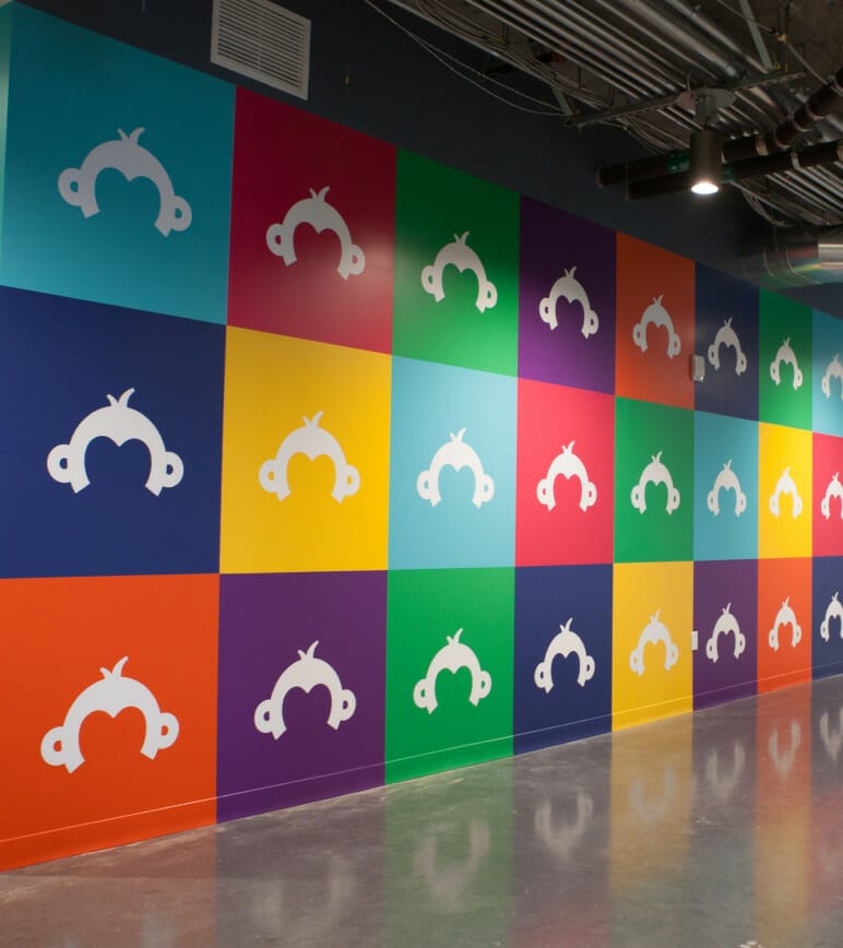 Survey logos on colorful tiles on wall