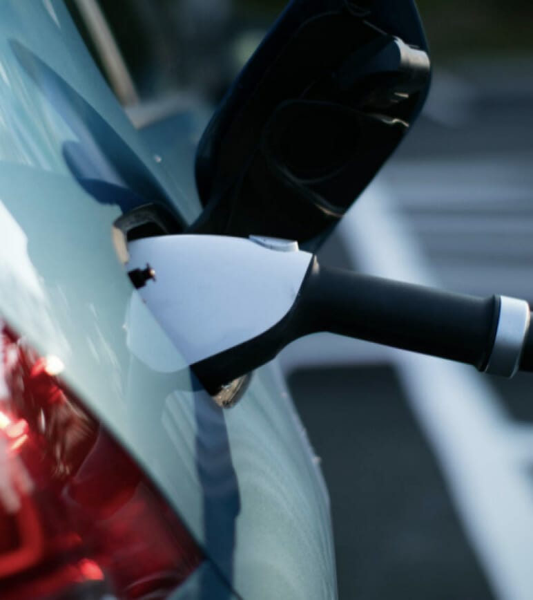 Electric car charger plugged into car