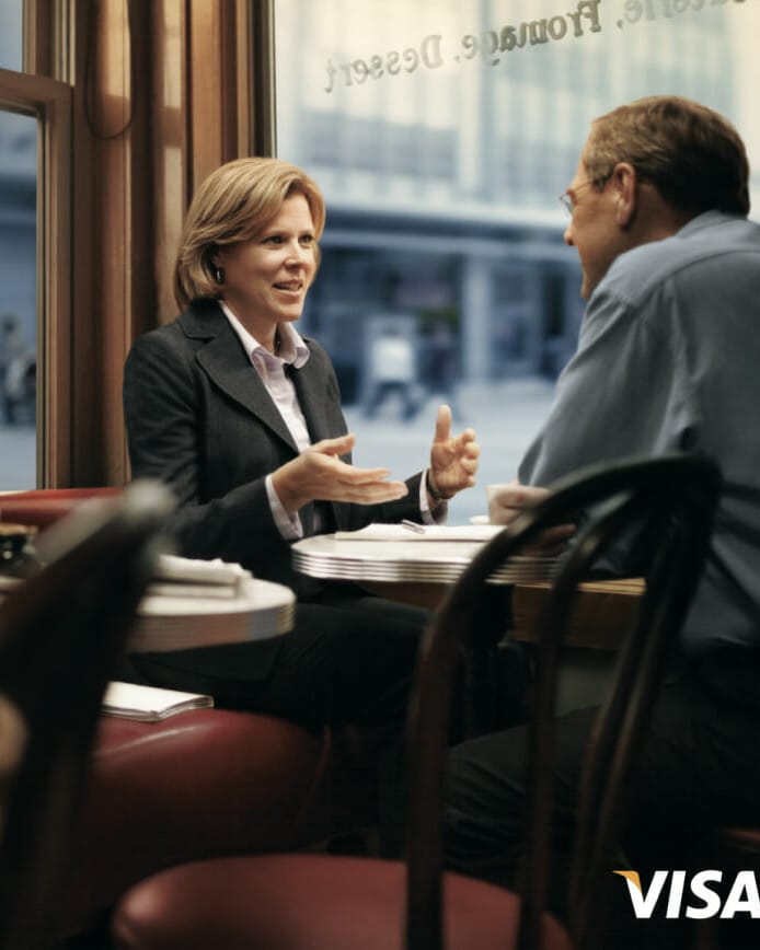 Businesswoman talking with businessman in restaurant