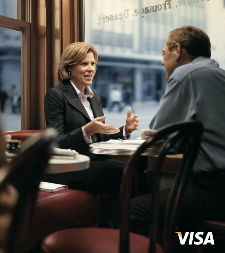 Businesswoman talking with businessman in restaurant